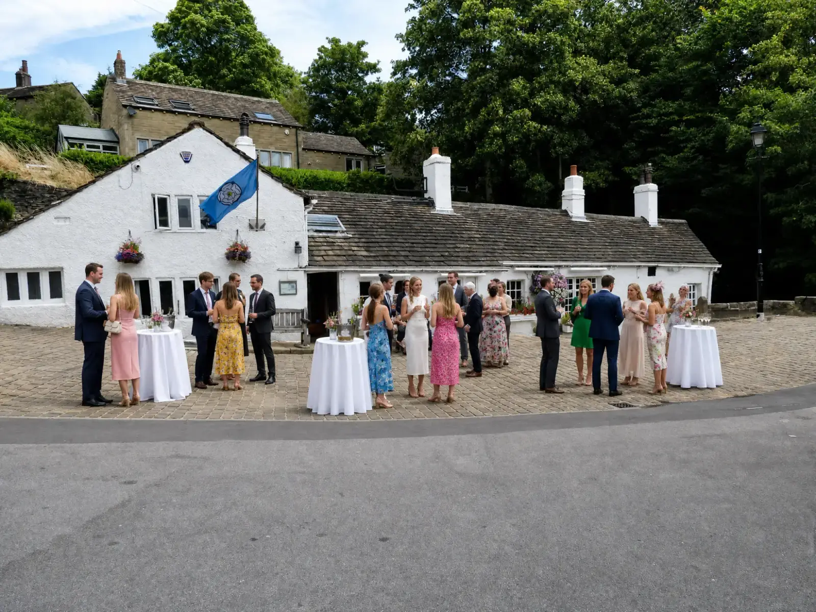 Wedding guests gathered outside The Old Bridge Inn in Ripponden