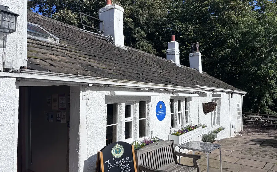 bright white frontage of old bridge inn