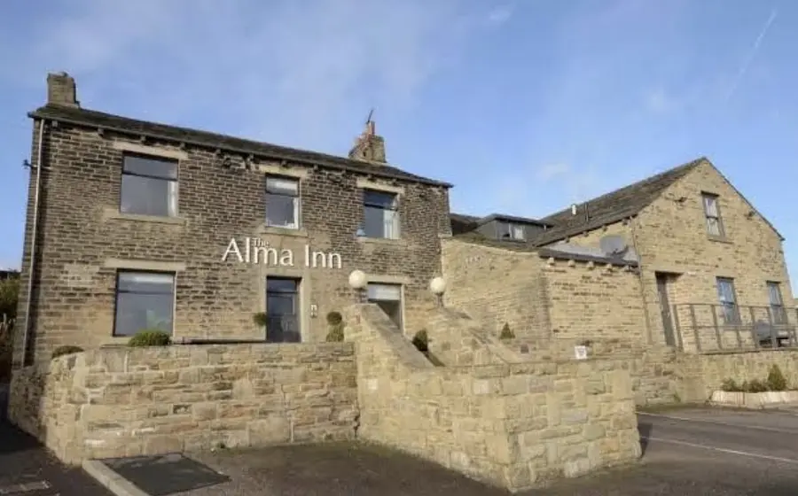 the alma inn in cottonstones in the sunshine from the front, stone brick