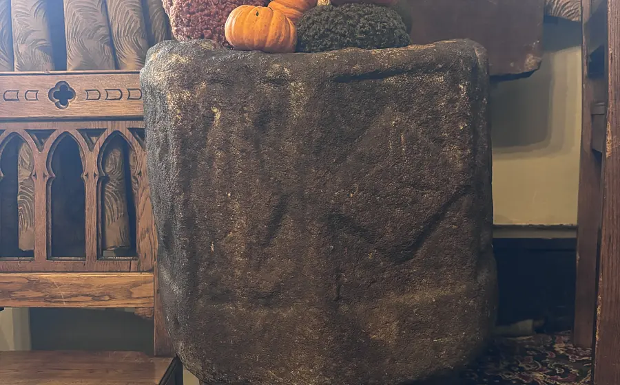 stone baptist font with engraving